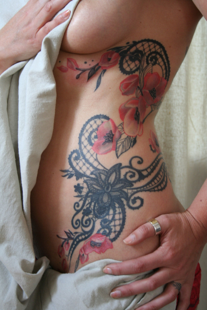 Feminine tattoo of floral black lace with pink flowers